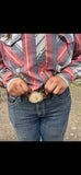 Elk antler burr belt buckle being worn on a leather belt